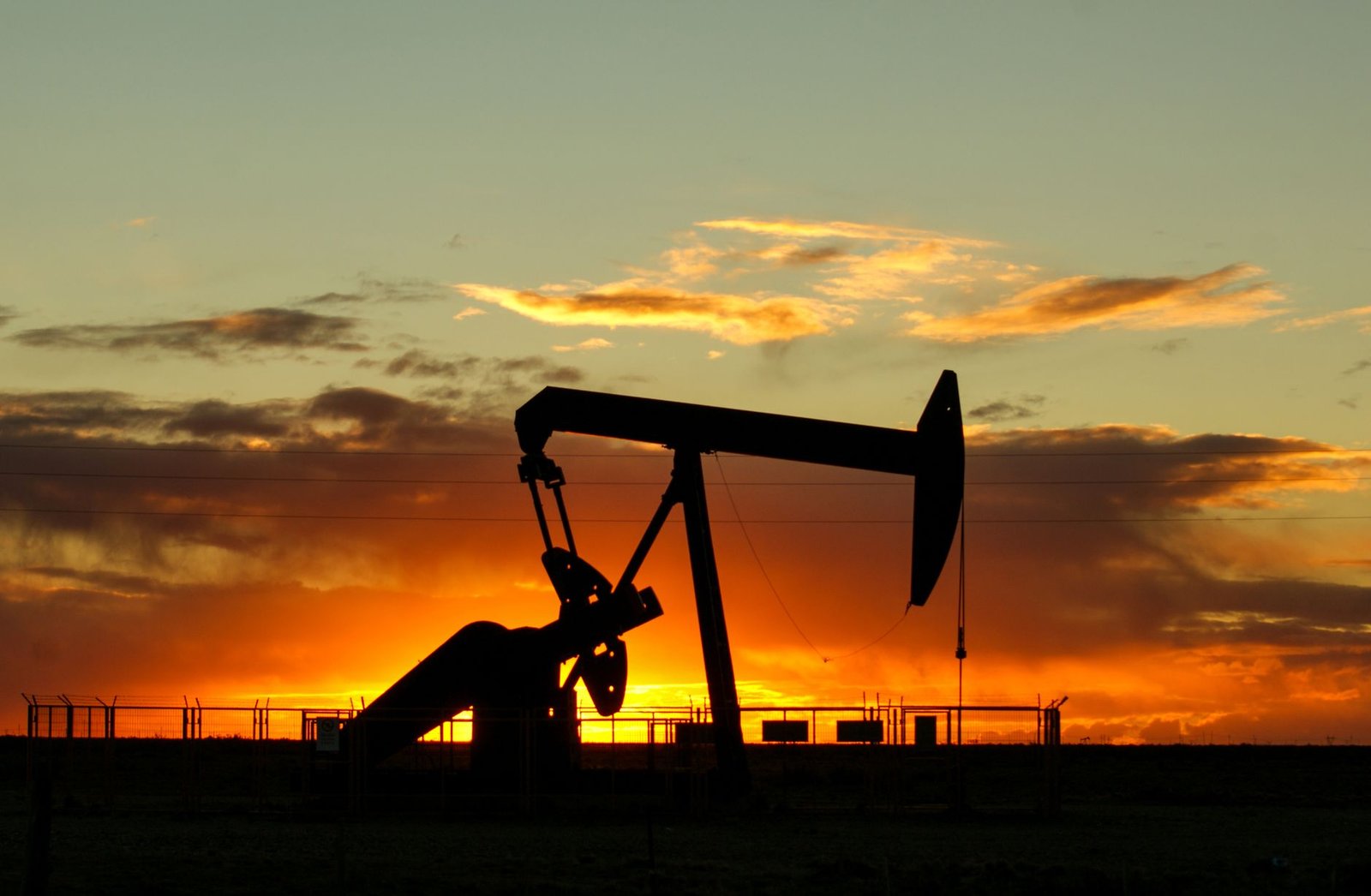 oil pump jack sunset — financial news